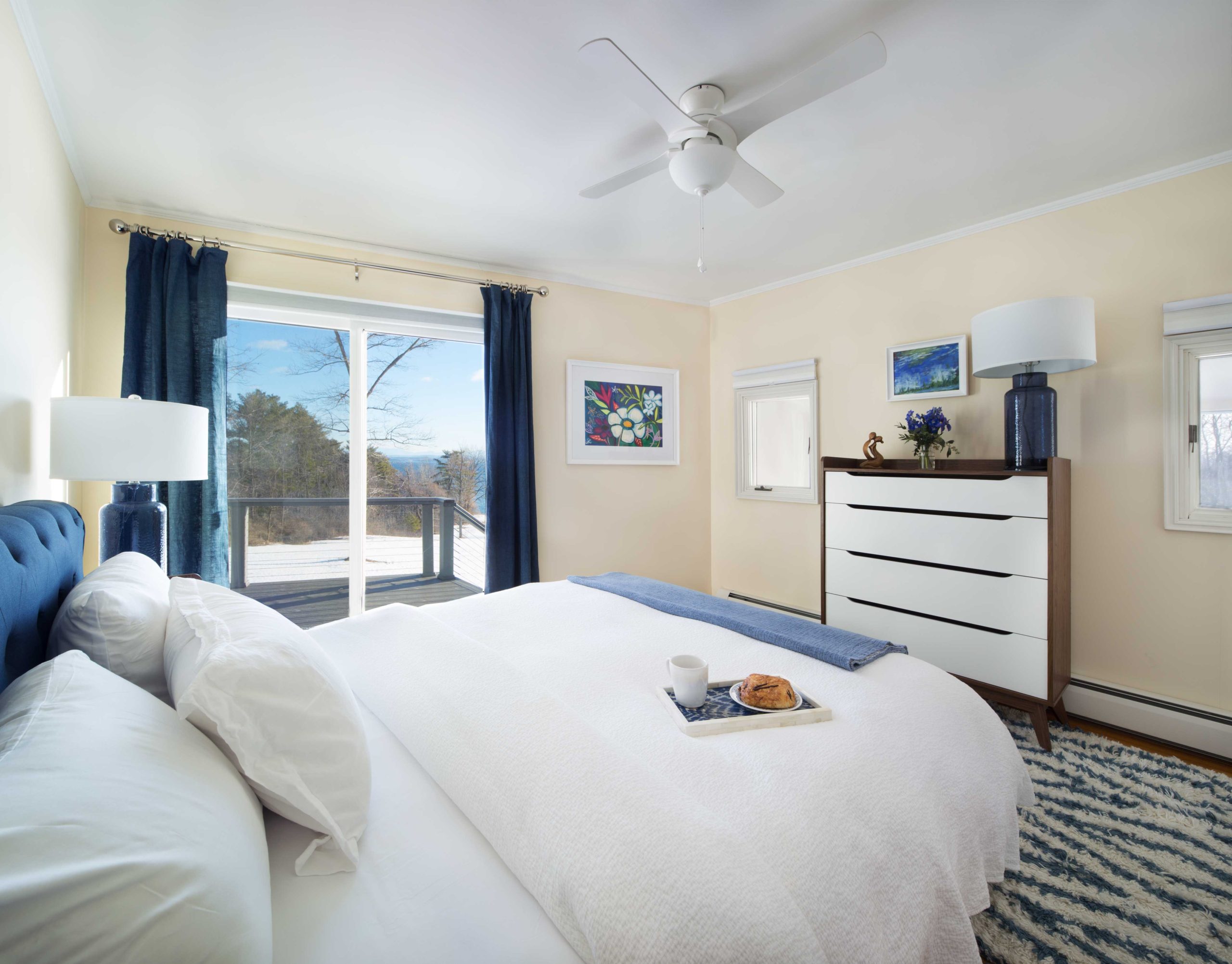 Lake views and sun prevail in the southern blue bedroom, with an organic queen mattress, all-organic bedding, and a private entrance to the deck.